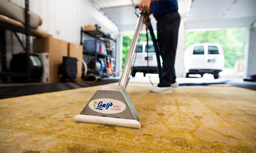 Steam cleaning a rug for a commercial client