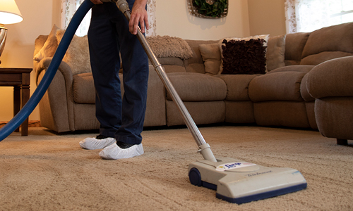 Vacuuming carpet in a residential home